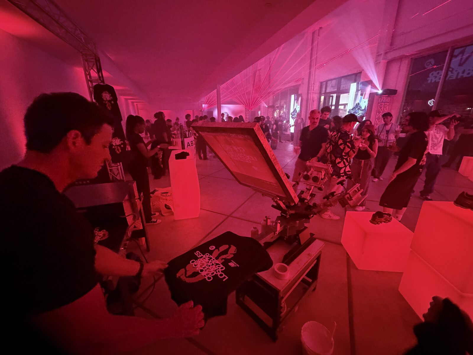 Live shirt printing station running front and center at a packed nighttime party